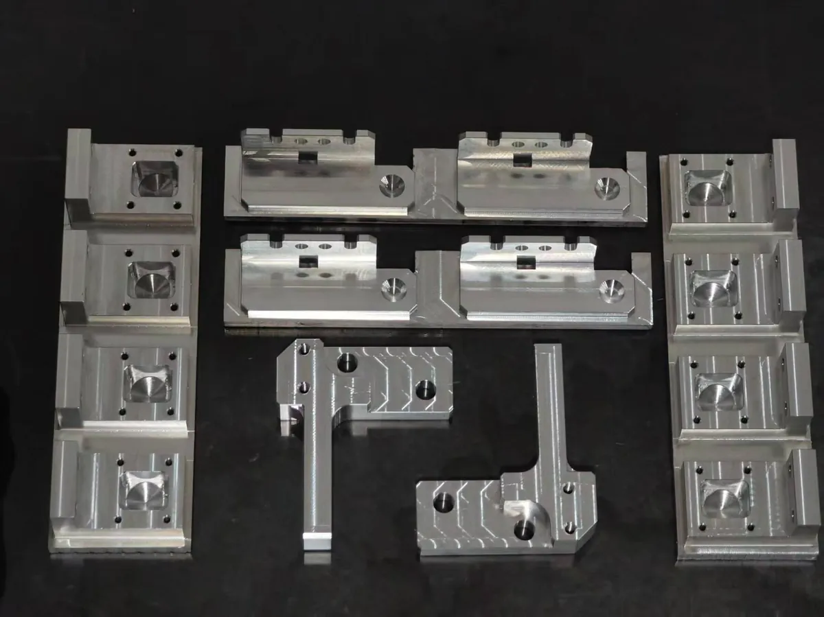 Set of CNC machined aluminum fixture blocks with milled pockets and locating slots
